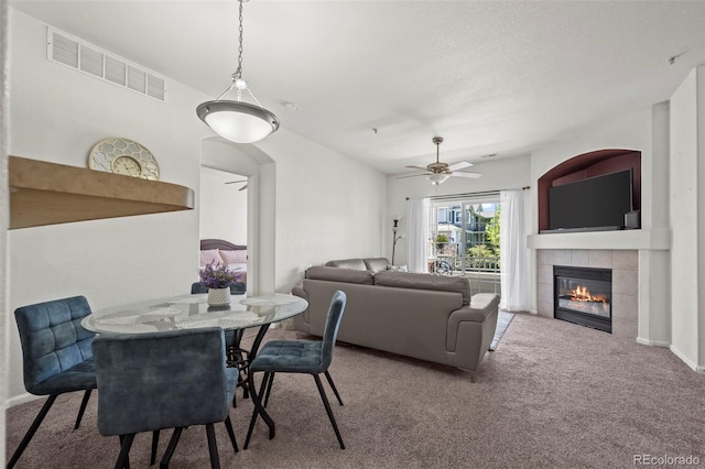 5255 Memphis St Unit 811, Denver, CO 80239 - carpeted dining space featuring a tile fireplace and ceiling fan