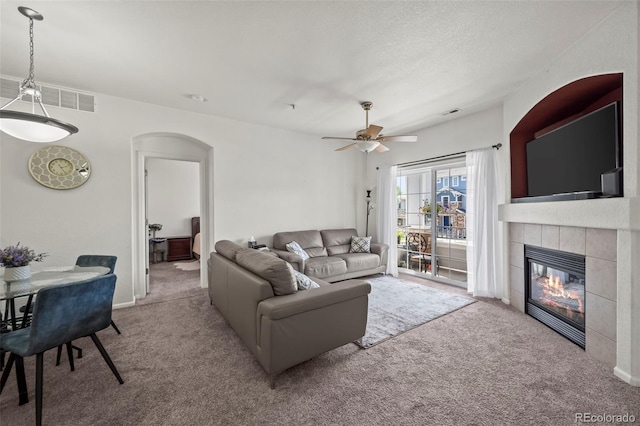 5255 Memphis St Unit 811, Denver, CO 80239 - living area with carpet, arched walkways, a fireplace, and ceiling fan