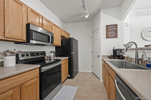 5255 Memphis St Unit 811, Denver, CO 80239 - kitchen with appliances with stainless steel finishes, light countertops, and track lighting