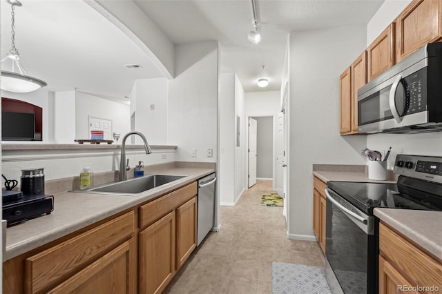5255 Memphis St Unit 811, Denver, CO 80239 - kitchen featuring appliances with stainless steel finishes, brown cabinets, pendant lighting, and light countertops