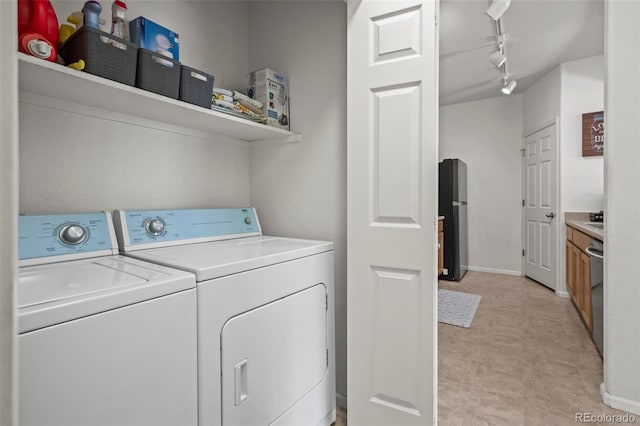 5255 Memphis St Unit 811, Denver, CO 80239 - laundry area featuring washing machine and clothes dryer, rail lighting, and light floors