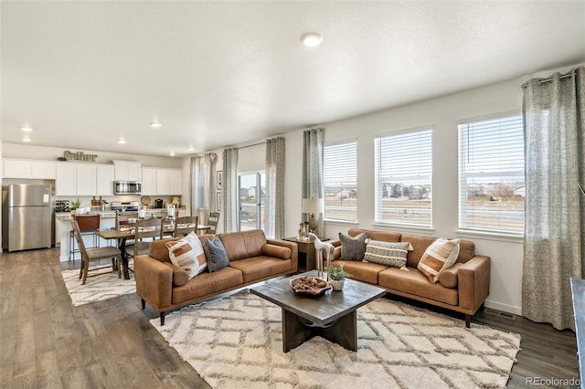 27664 E Byers Ave, Aurora, CO 80018 - living area featuring plenty of natural light, dark wood-style flooring, recessed lighting, and baseboards