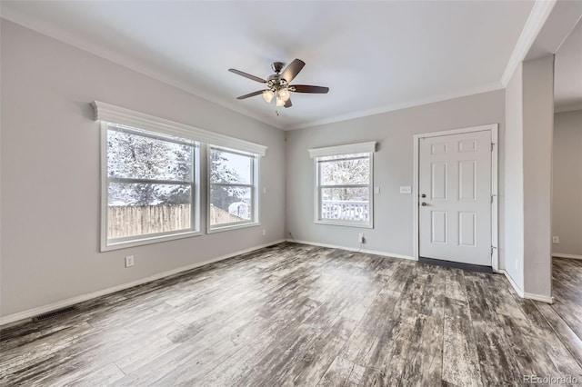 empty room with hardwood / wood-style floors, ceiling fan, and ornamental molding