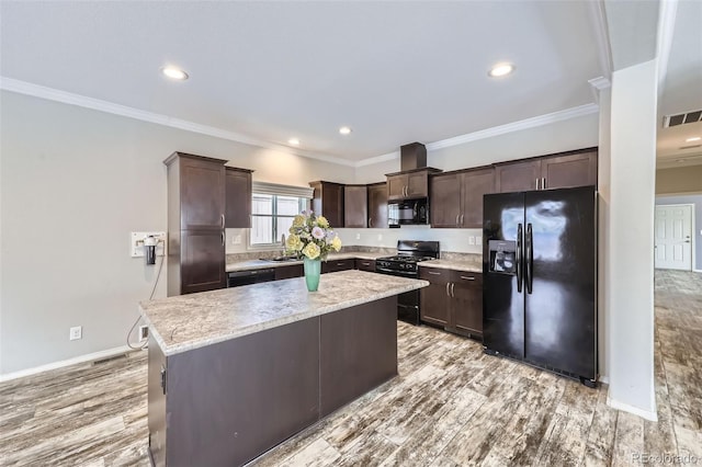 kitchen with black appliances, light wood-type flooring, ornamental molding, dark brown cabinets, and a kitchen island