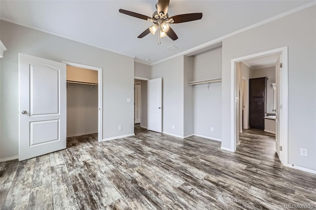 unfurnished bedroom featuring ceiling fan, dark hardwood / wood-style flooring, ensuite bathroom, and ornamental molding