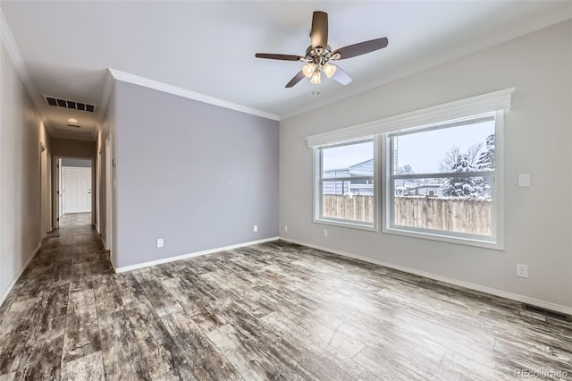 empty room featuring dark hardwood / wood-style floors, ceiling fan, and ornamental molding