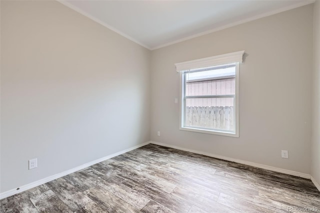 spare room with wood-type flooring and crown molding