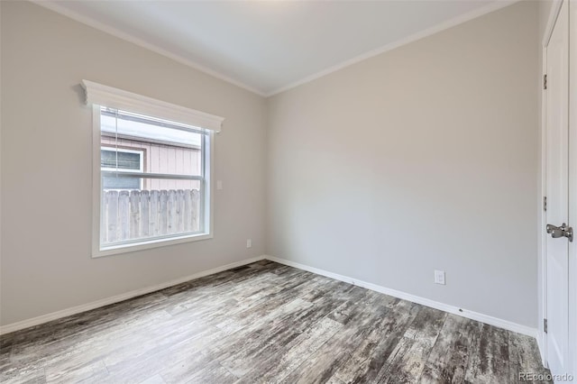 spare room featuring wood-type flooring and ornamental molding