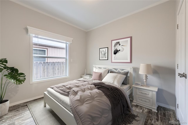 bedroom featuring dark wood-type flooring and ornamental molding