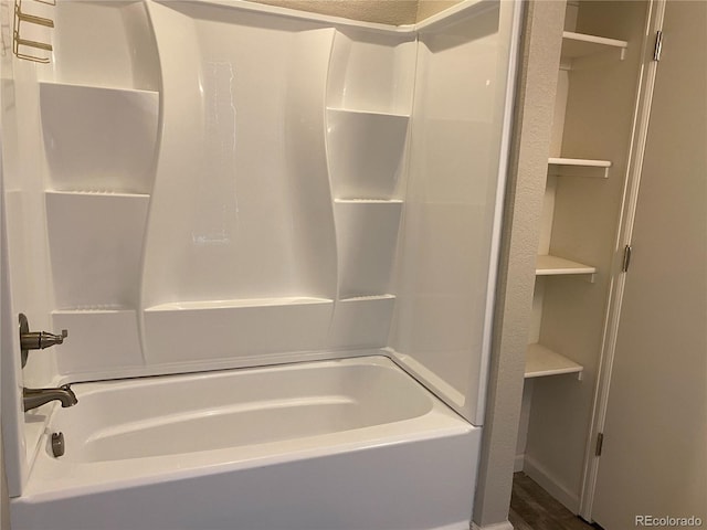 bathroom with shower / tub combination and hardwood / wood-style flooring