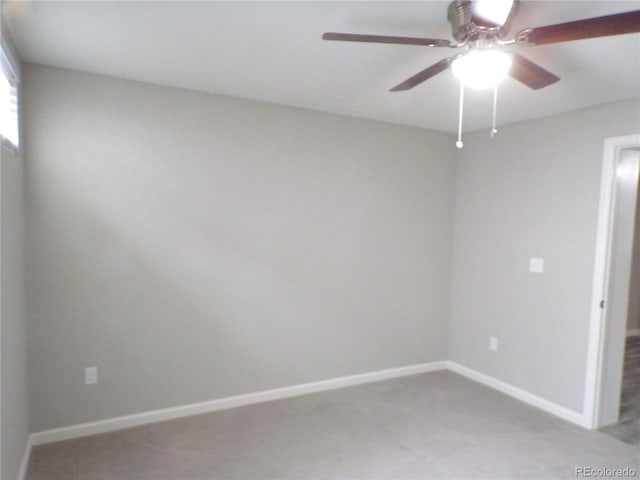 carpeted spare room featuring ceiling fan