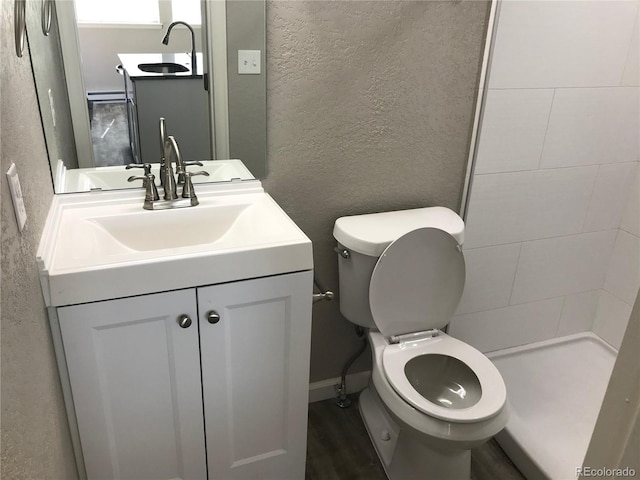 bathroom with vanity, toilet, and baseboard heating