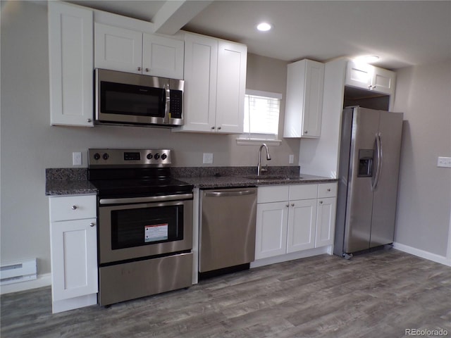 kitchen with sink, white cabinets, stainless steel appliances, and light wood-type flooring