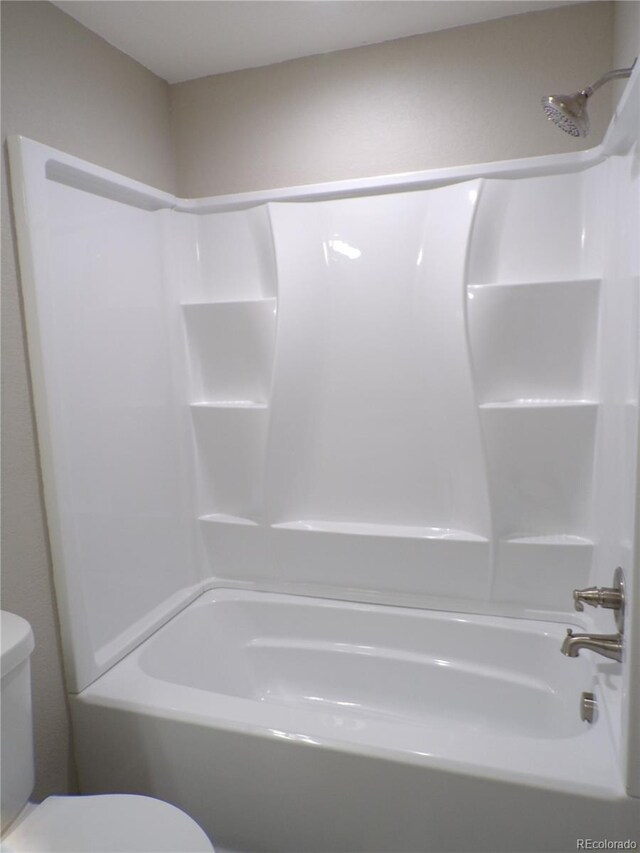 bathroom with toilet and bathtub / shower combination