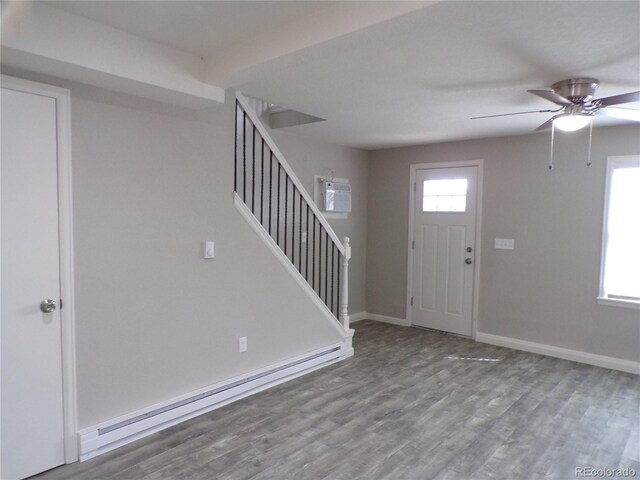 entryway featuring baseboard heating, a wealth of natural light, and light hardwood / wood-style flooring