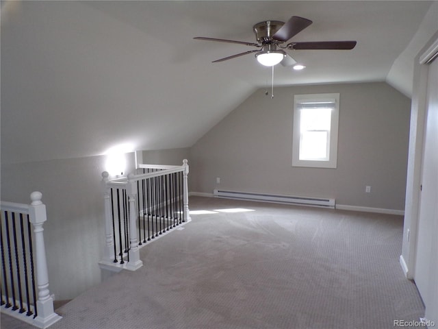 bonus room with ceiling fan, vaulted ceiling, light carpet, and a baseboard heating unit