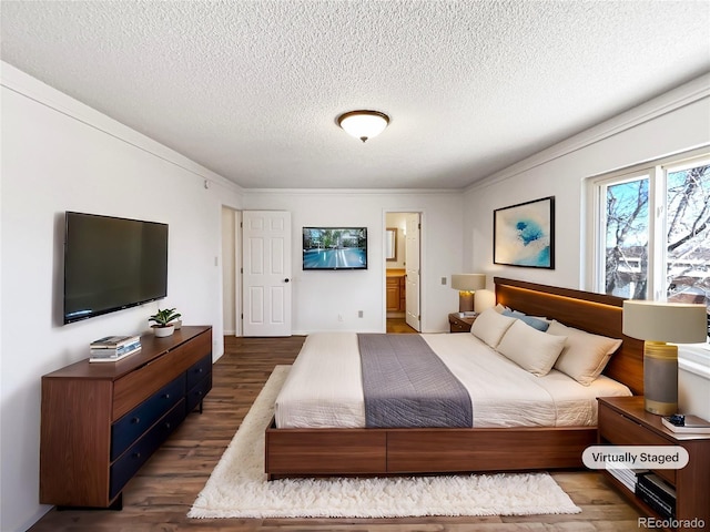 bedroom with crown molding, dark wood finished floors, a textured ceiling, and ensuite bathroom