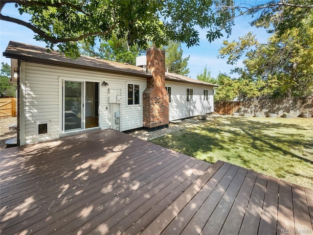 wooden terrace with a yard and fence