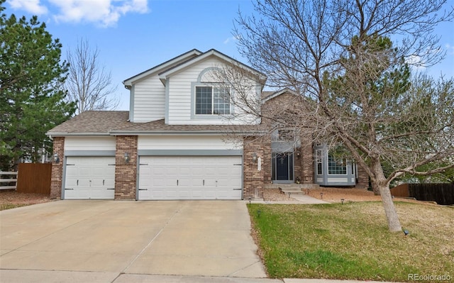 traditional-style home with brick siding, fence, and concrete driveway
