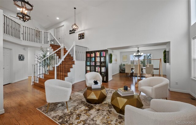 10383 Erin Pl, Lone Tree, CO 80124 - living area featuring a high ceiling, a notable chandelier, wood finished floors, and stairway