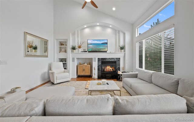 10383 Erin Pl, Lone Tree, CO 80124 - living room with ceiling fan, built in shelves, recessed lighting, wood finished floors, and a high end fireplace