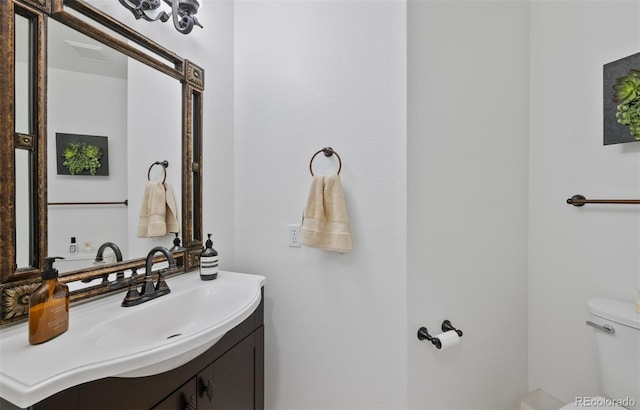 bathroom featuring vanity and toilet