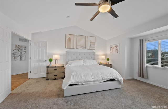 carpeted bedroom featuring baseboards, ceiling fan, vaulted ceiling, and visible vents