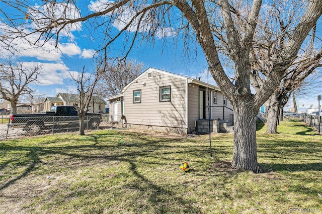 view of side of property with a yard