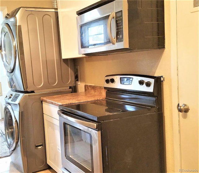 laundry area featuring stacked washer and dryer