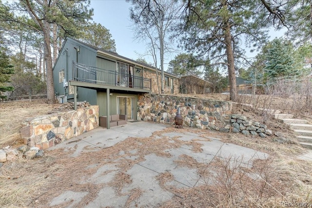 rear view of house with a deck and a patio area