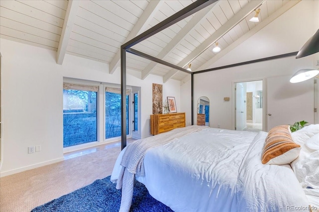 carpeted bedroom featuring arched walkways, ensuite bath, lofted ceiling with beams, and baseboards