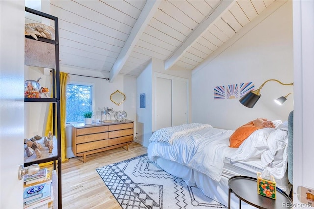 bedroom featuring wood ceiling, vaulted ceiling with beams, and light wood-style flooring