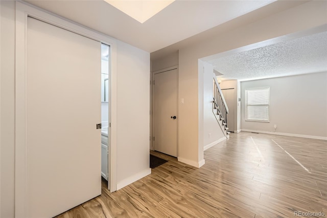 foyer featuring a textured ceiling and light hardwood / wood-style floors