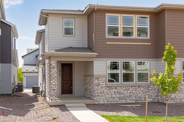 1415 Great Western Dr, Longmont, CO 80501 - view of front of house with stone siding and central air condition unit