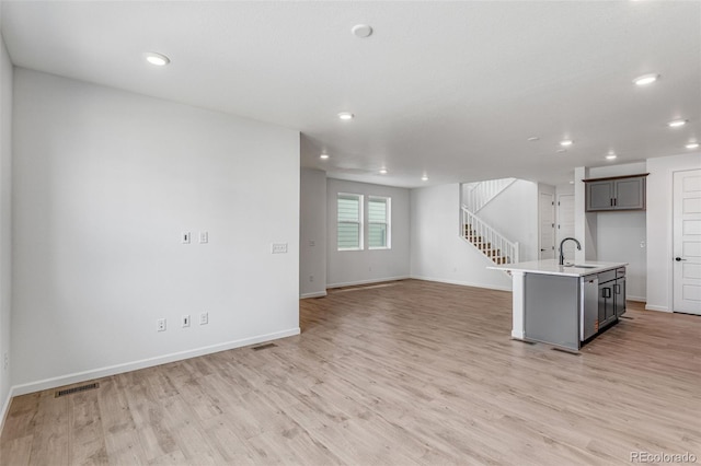 1415 Great Western Dr, Longmont, CO 80501 - kitchen featuring a sink, baseboards, light wood-style floors, recessed lighting, and light countertops