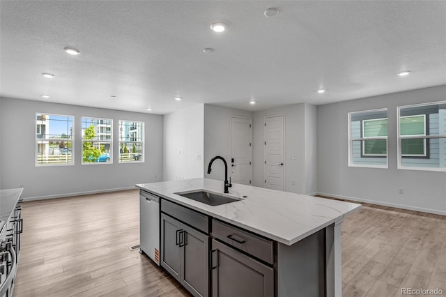 1415 Great Western Dr, Longmont, CO 80501 - kitchen with a sink, open floor plan, dishwasher, light wood-style flooring, and light stone counters