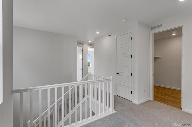 1415 Great Western Dr, Longmont, CO 80501 - hallway with an upstairs landing, recessed lighting, carpet flooring, and baseboards