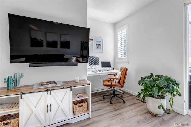 office with light wood-type flooring