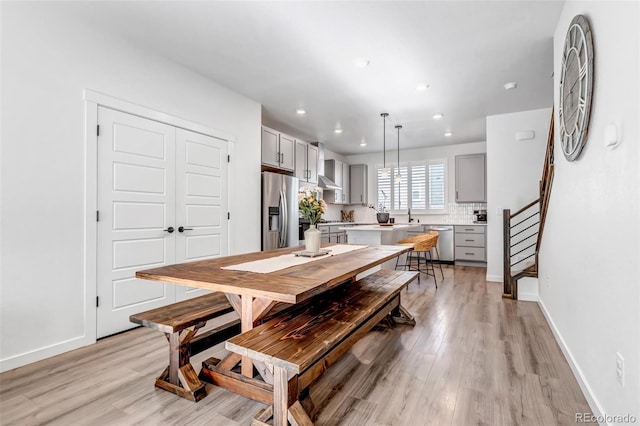 dining room with sink and light hardwood / wood-style floors