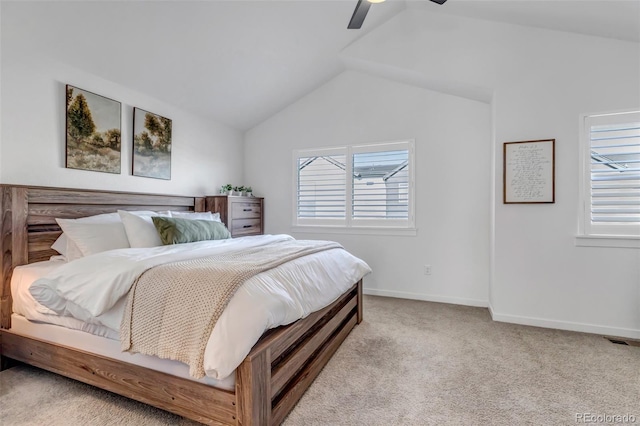 bedroom with ceiling fan, light colored carpet, vaulted ceiling, and multiple windows