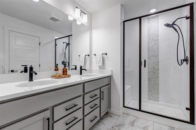 bathroom with vanity and a shower with shower door