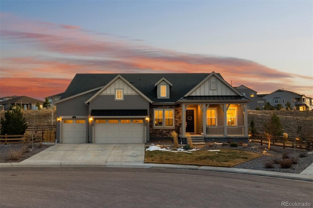 view of front of property featuring covered porch and a garage