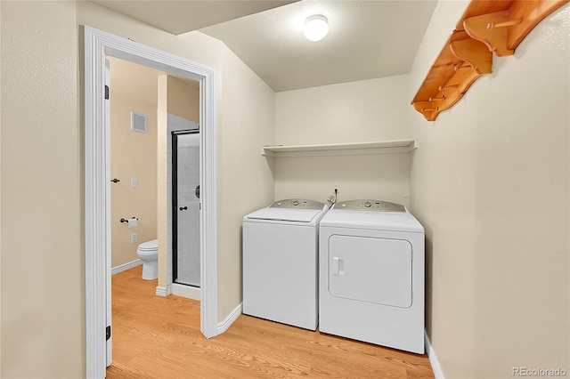 35675 Cheyenne Trl, Elizabeth, CO 80107 - laundry room featuring light wood-type flooring and washing machine and dryer
