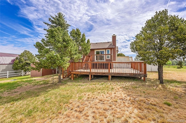 35675 Cheyenne Trl, Elizabeth, CO 80107 - back of house with a wooden deck and a chimney