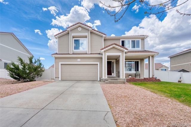 traditional home with a garage and concrete driveway