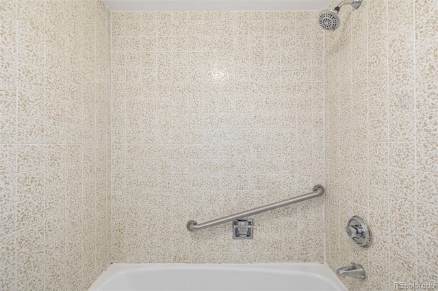 bathroom view of shower / bath combination and a sink
