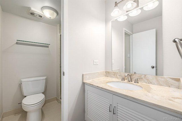 bathroom featuring vanity, toilet, baseboards, and tile patterned flooring