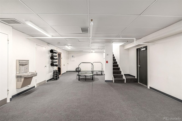workout room featuring baseboards and carpet floors