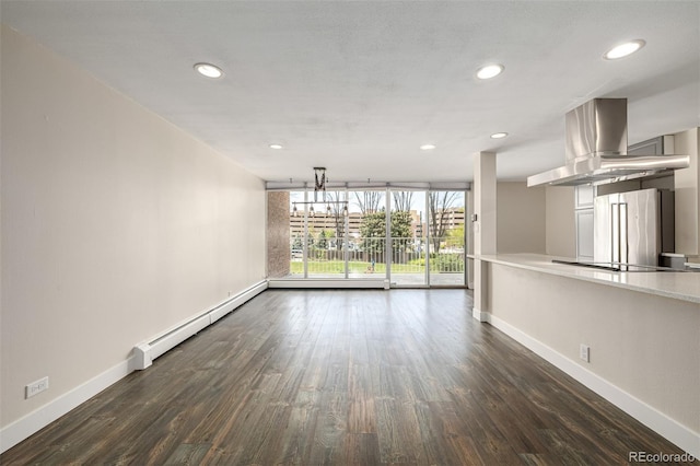 unfurnished living room featuring baseboards, baseboard heating, dark wood-style floors, and recessed lighting