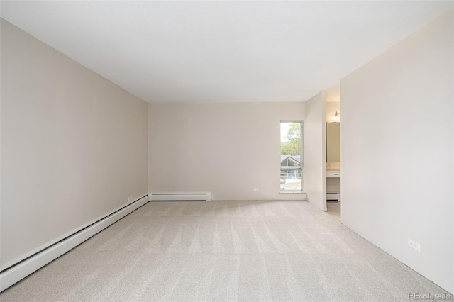 carpeted empty room with a baseboard heating unit